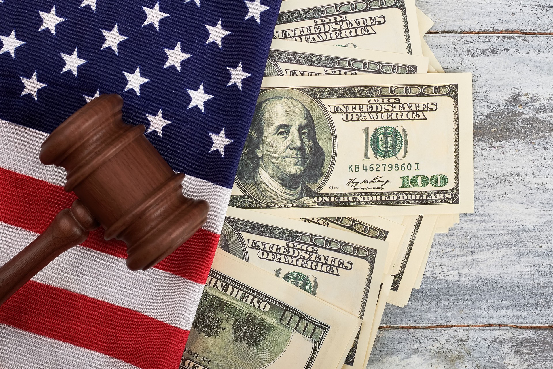 Gavel, dollars and American flag.